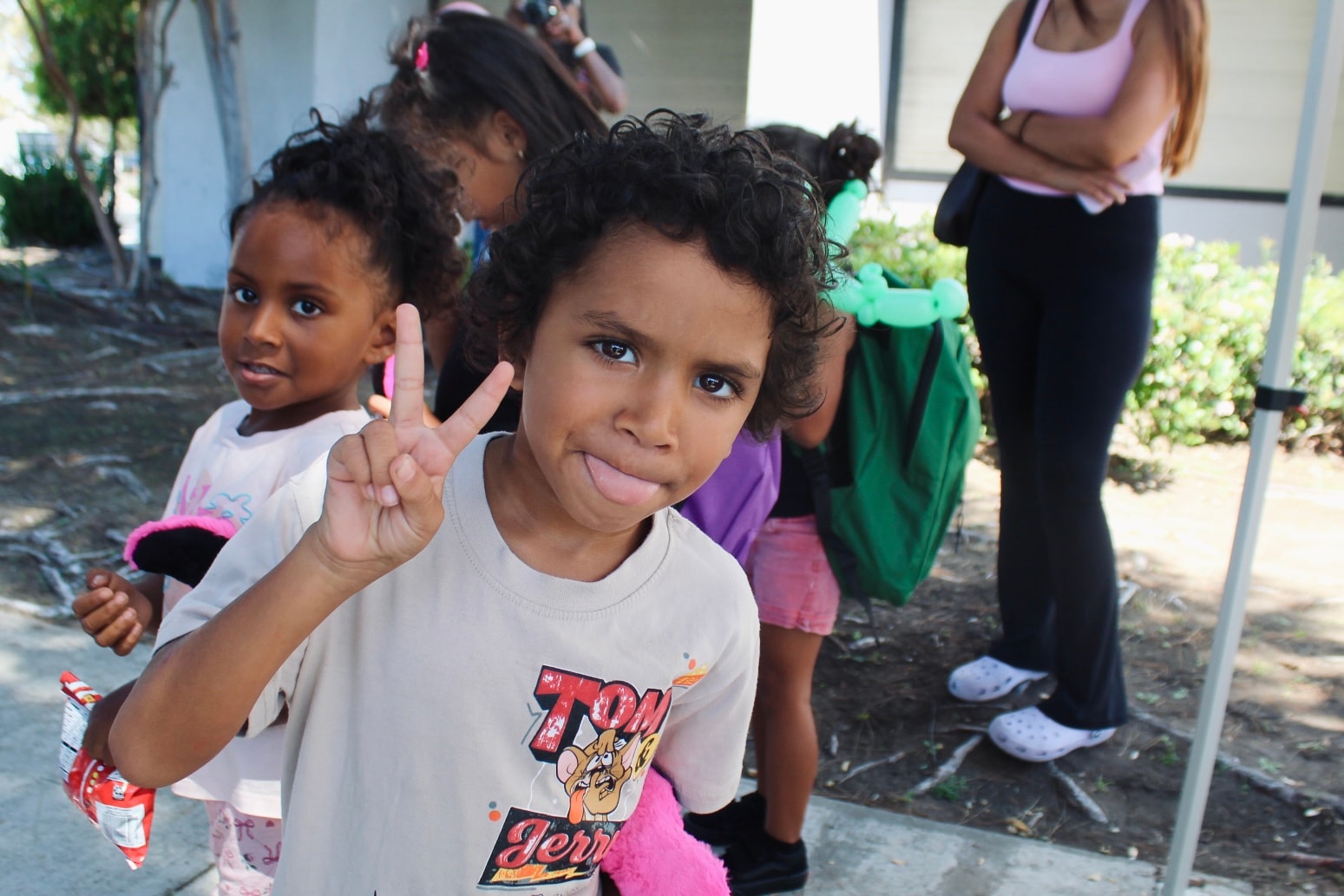 Children celebrating at the backpack giveaway event